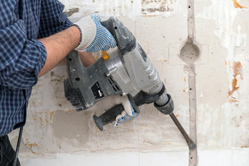 Making electrical channel with hammer drill in the concrete wall
