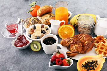 Breakfast served with coffee, orange juice, croissants and fruits. Balanced diet.