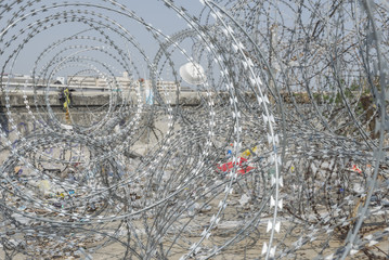 Coiled barbed wire fencing at forbidden area, war zone
