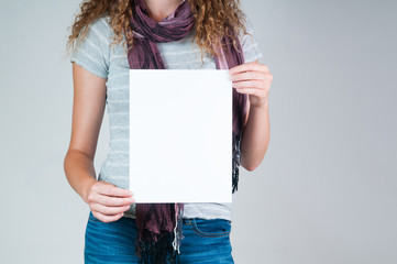 woman holding a piece of blank paper