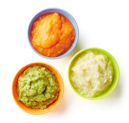 Three bowls of baby puree isolated on white from above