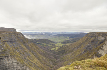 Nervion river source, waterfall in the Delika canyon (Alava) on a cloudy day at winter. Basque Country, Spain.