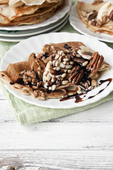 Traditional homemade pancakes. Celebration of Maslenitsa, Shrovetide. Close-up, selective focus. White vintage wooden background.