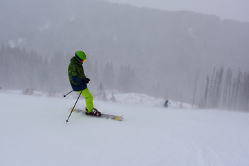 Skier on a steep snowy slope, winter blizzard in the mountain, Aleko Ski Resort, Vitosha, Bulgaria