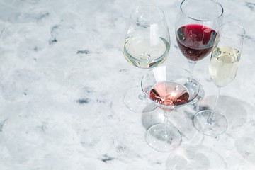Wine tasting concept - glass with different wine on marble background