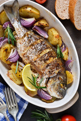 Baked dorado with Provencal herbs and potatoes.