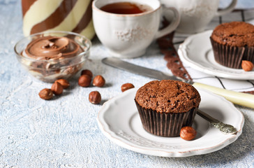 Chocolate muffins with nuts and peanut butter on a concrete background