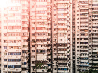 Fototapeta na wymiar Windows and balconies of many residential apartments in chinese city, China.