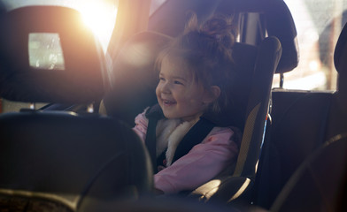 car child seat- smiling girl in her car seat.