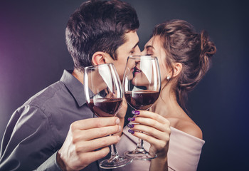 Couple celebrating Valentines day drinking red wine