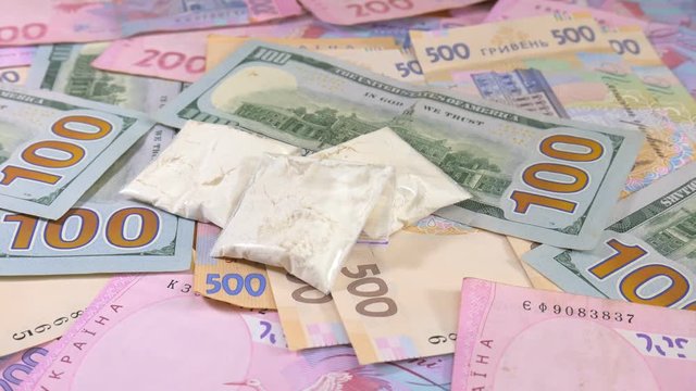 Drugs and cash money everywhere on a table. Closeup shot.