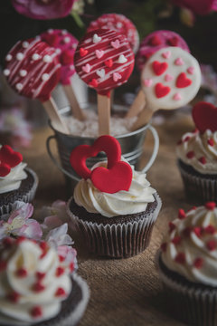 Valentine day background with cake pops and cupcakes,selective focus