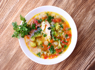 Soup on wooden background top view.