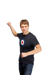 A very aggressive young man. Guy in casual clothes is going to fight. The student was angry, he shows a fist. A football fan, a bully. The bandit beats his fist.