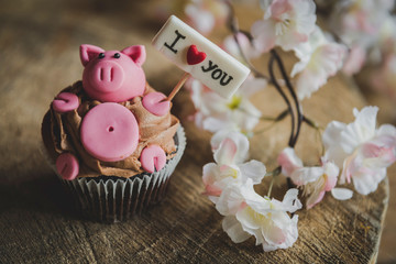 Sweet pig with I love you sign on the top of cup cake,selective focus