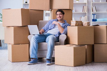 Young man moving in to new house with boxes