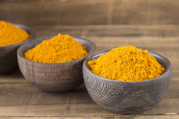 Turmeric powder in wooden bowls