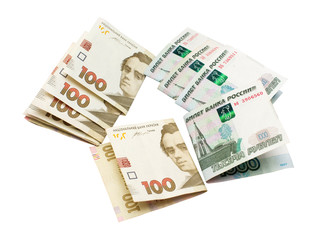 One hundred Ukrainian national currency hryvnia and one thousand rubles of Russian isolated on white background. Finance, international politics