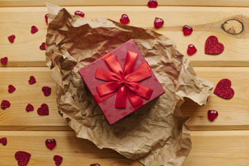 A gift in a beautiful crane box tied with a ribbon on a wooden surface.