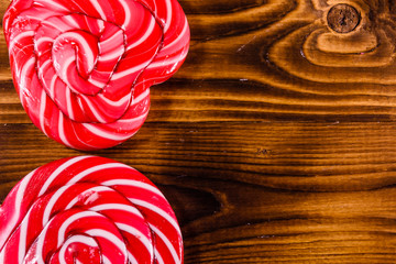 Different sweet lollipops on a wooden table. Top view