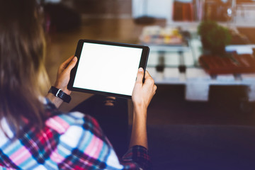 Hipster girl using tablet technology in home, girl person holding computer with blank screen on background bokeh, female hands texting on relax holiday, mockup templates gadget, lifestyle concept