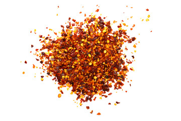 Red dry chili pepper flakes over white background