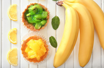 Composition tasty tartlets on wooden background, top view