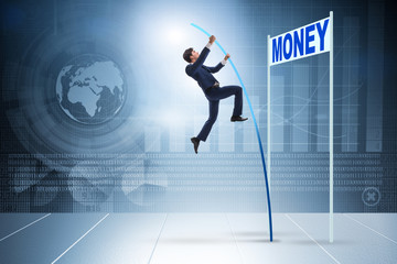 Businessman jumping over money in business concept