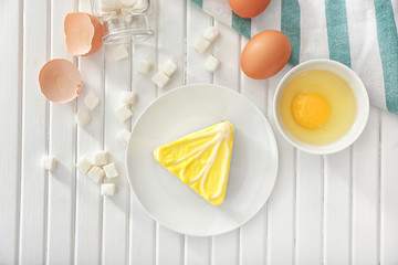 Composition with tasty souffle cake on wooden background, top view