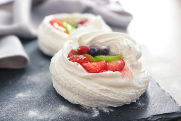 Tasty Pavlova cake on slate plate