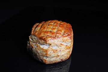 Scone. Pastry round scone on black reflective studio background. Isolated black shiny mirror mirrored background for every concept.