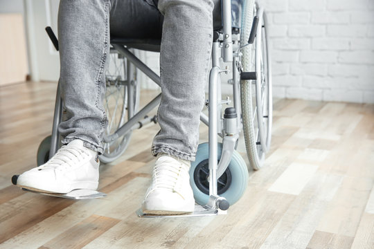 Man in wheelchair indoors, closeup