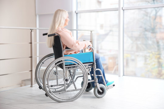 Mature woman in wheelchair indoors