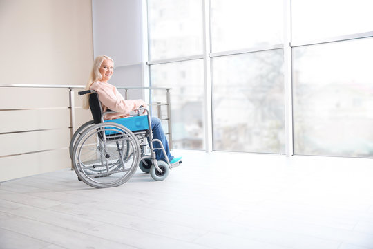 Mature woman in wheelchair indoors
