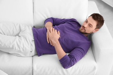 Young man lying on sofa at psychologist's office