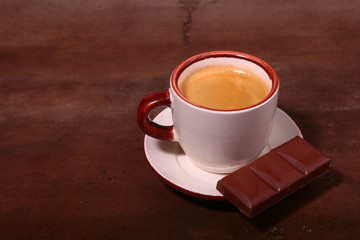 Coffee cup and chocolate on wooden table texture. Coffeebreak