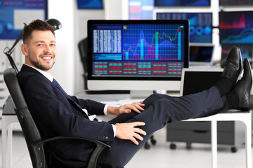 Young stock exchange trader at workplace