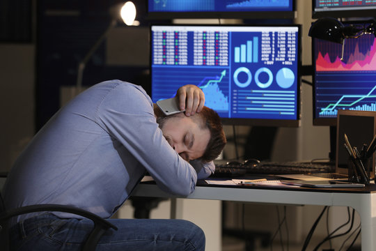 Tired stock exchange trader sleeping in office - Powered by Adobe