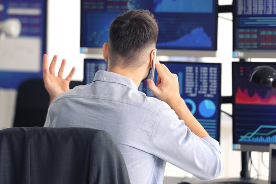 Young stock exchange trader working in office