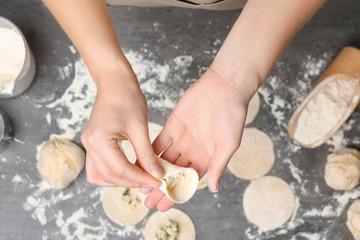 Woman making dumplings, closeup