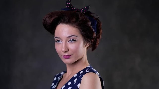 fashion portrait of retro pin up model with blue bow and beautiful make up