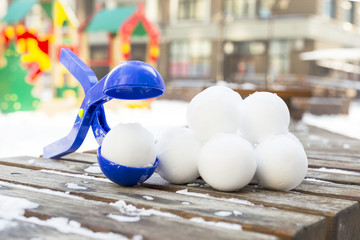 Snowball maker tool with set of ready snowballs .