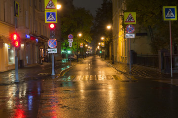 quiet city street at rainy night. background