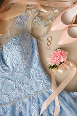 Blue wedding dress, bridal shoes on high heels and wedding rings. Marriage concept