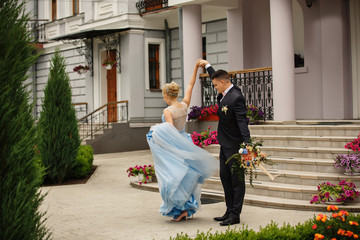 Fototapeta na wymiar Happy marriage. Bride and groom dancing at wedding day. Newlyweds couple in love