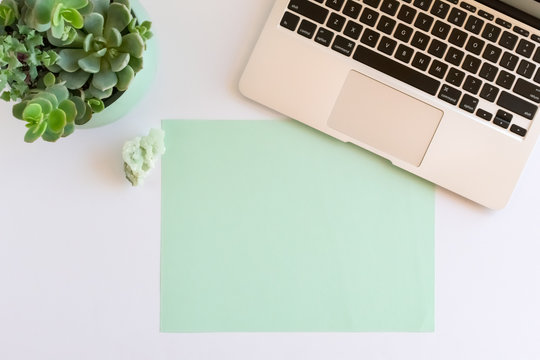 Laptop Computer, Succulents, Apophyllite Crystal, Blank Paper at Modern Workspace