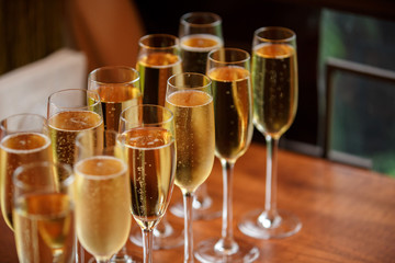 Rows of champagne and wine glasses on alcohol party and wedding reception