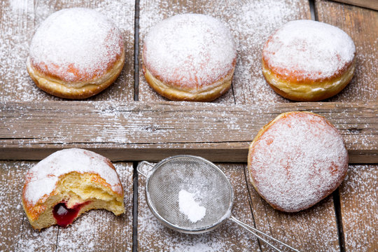 Traditional Polish donuts on wooden background Tasty doughnuts with jam.