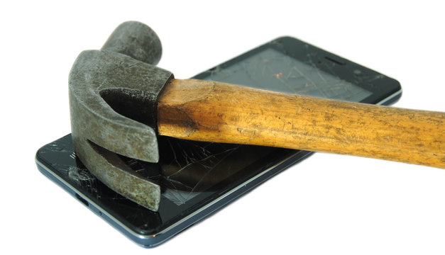 Martelo pousado em cima de um smartphone com o display partido
