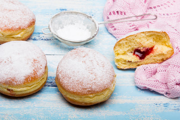 Traditional Polish donuts on wooden powder. Tasty doughnuts with jam.